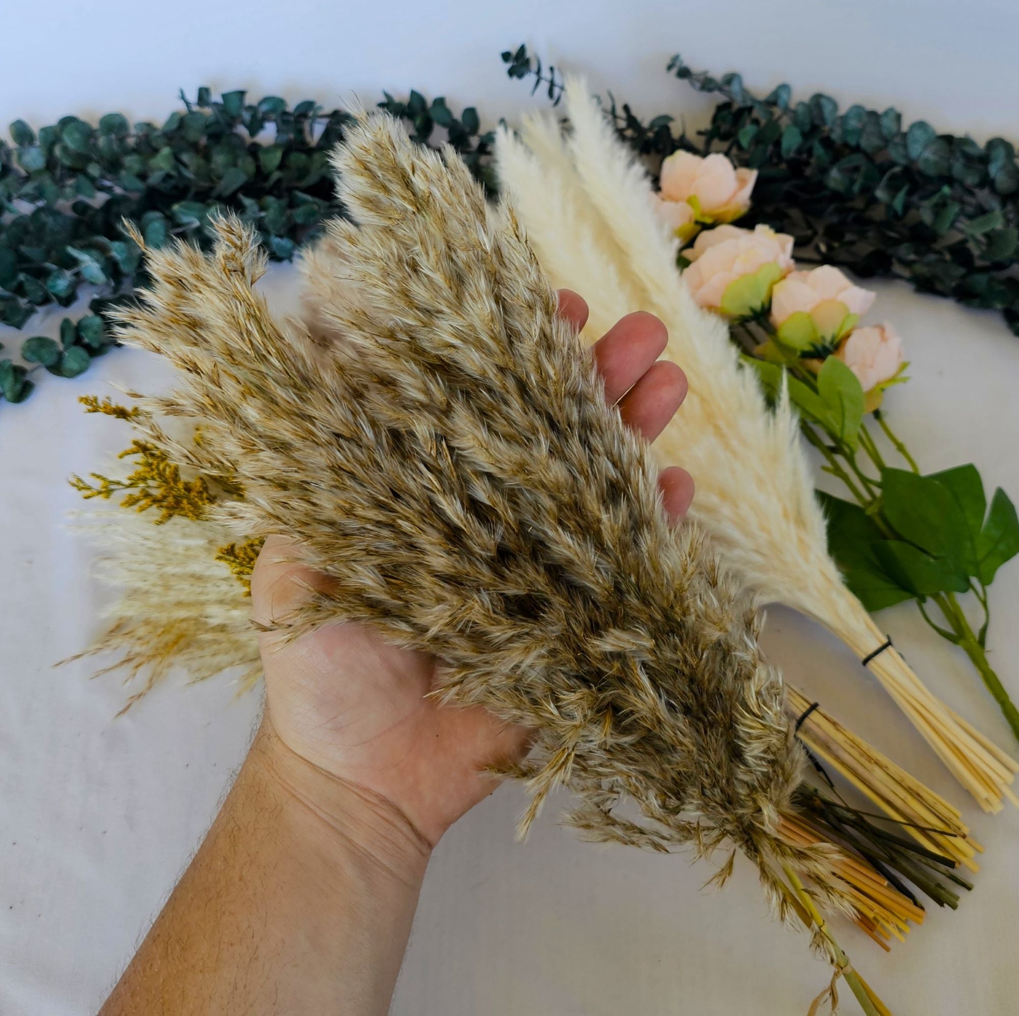 pampas grass laid out with silk flower