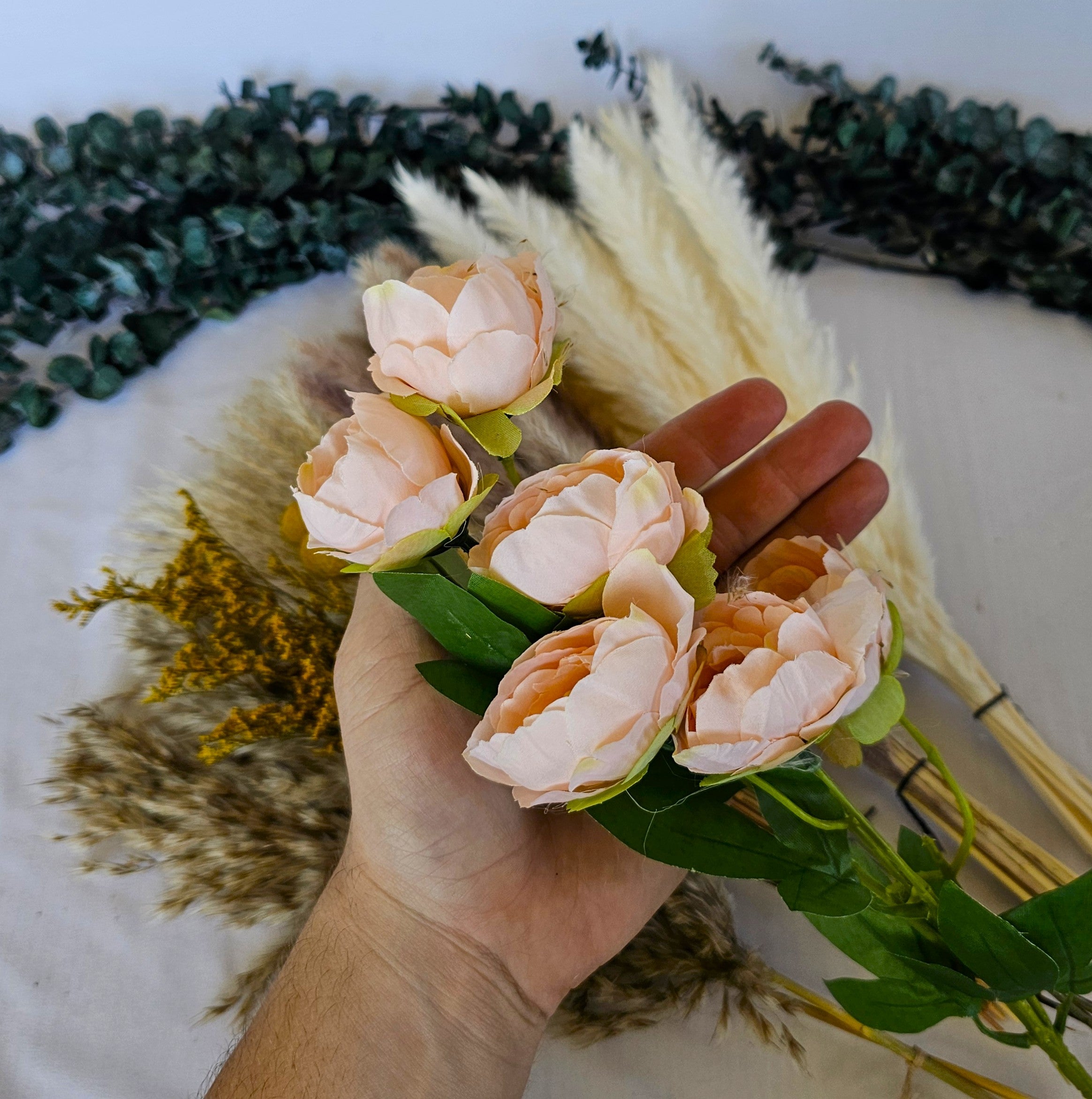 pampas grass laid out with silk flower